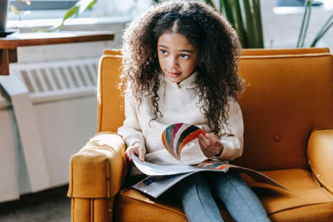 a photo of a child reading in a well lite room