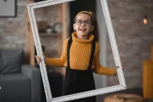 A photo of a smiling girl in a photo frame